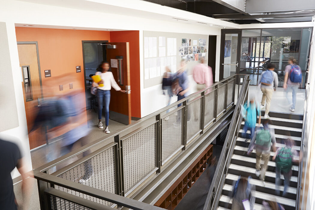 students walking through hall in college building