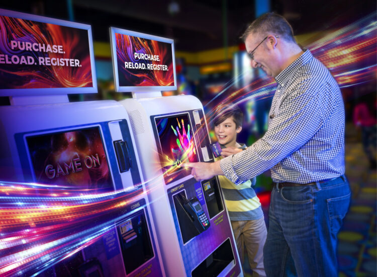 father and child using a dave and busters kiosk